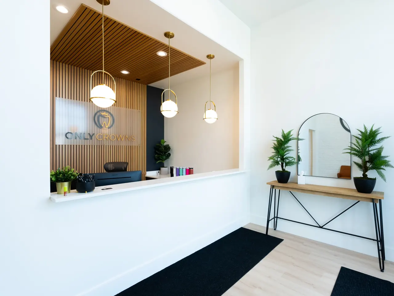 Only Crowns reception with warm wood, comfortable seating and the gold logo